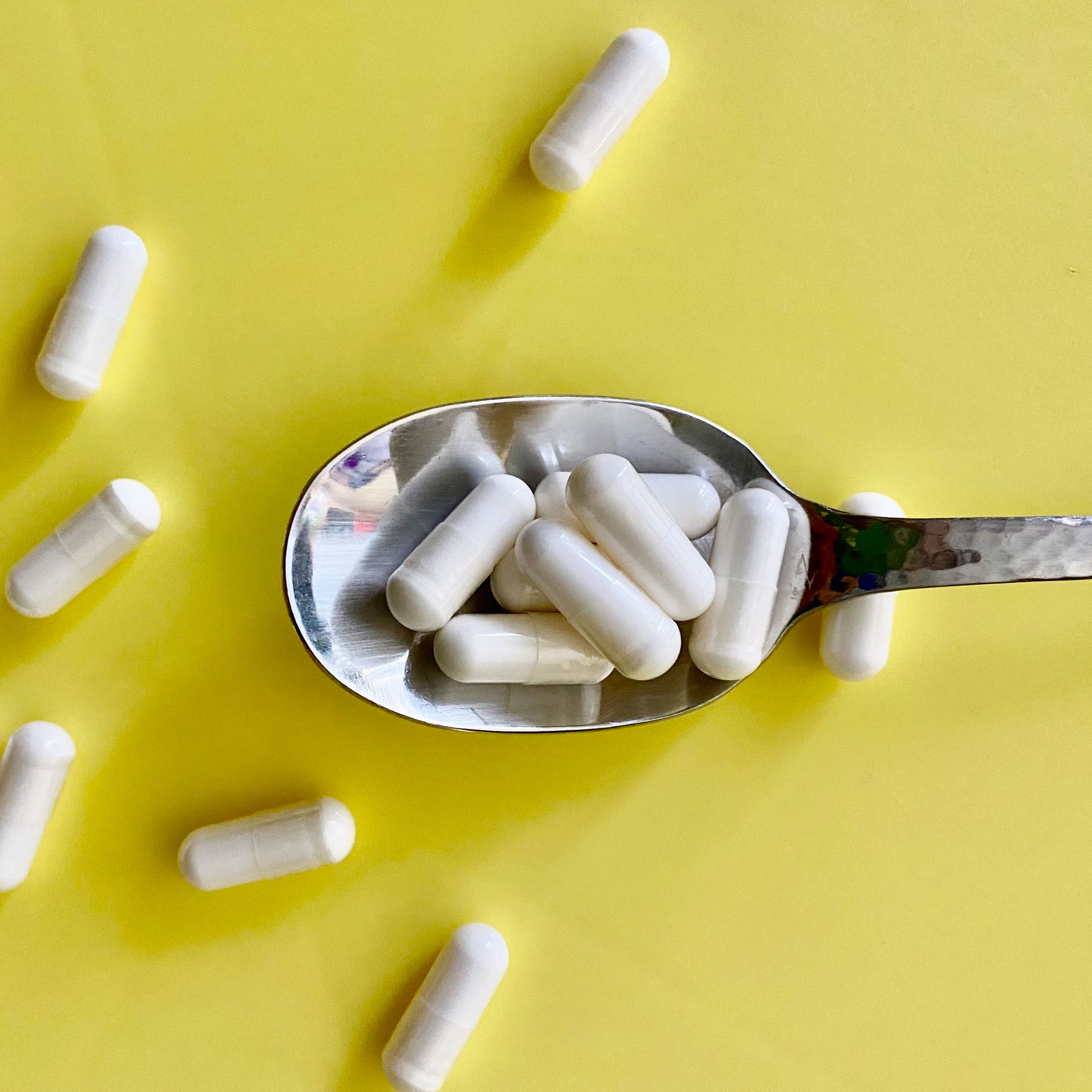 White tablets in a spoon